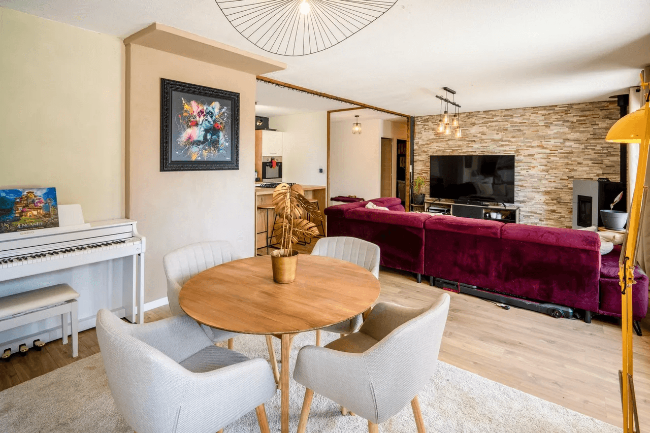 Séjour avec piano et mur en pierre apparente — photo immobilière intérieure